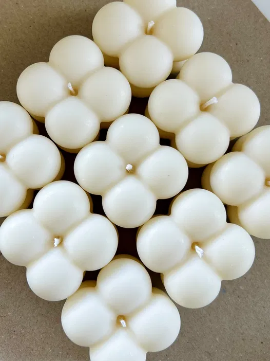 Cluster of Cream-Colored Bubble Candles on Brown Background