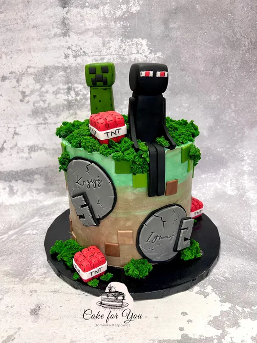 Minecraft-inspired cake with green and black fondant figures on top, decorated with TNT elements and lush greenery.