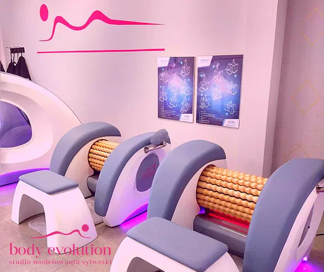  Studio modelowania sylwetki Body Evolution z urządzeniami do masażu i plakatami instruktażowymi na ścianie. 