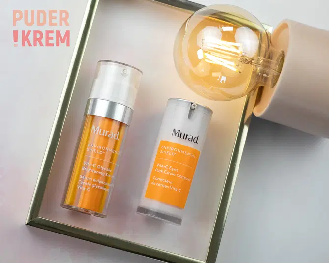  Produkty kosmetyczne Murad Environmental Shield z witaminą C w eleganckiej aranżacji z żarówką, idealne do pielęgnacji skóry i redukcji cieni pod oczami. 