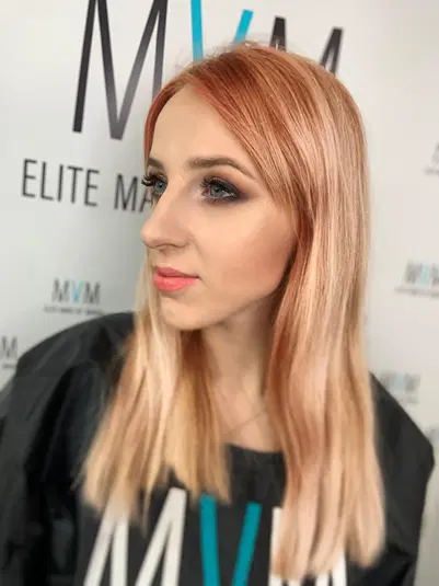  A person with stylish makeup and long, straight hair poses against a backdrop with the text Elite Make Up. 