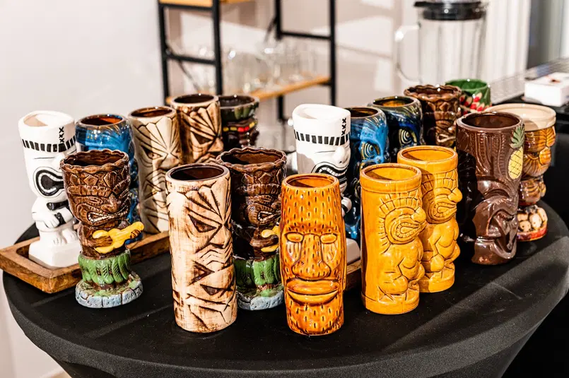  Ceramiczne kubki Tiki na stole, kolorowe wzory, impreza tematyczna, bary tropikalne, ozdobne naczynia, dekoracje egzotyczne, kolekcja kubków. 
