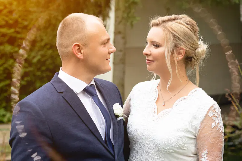  Para młoda w dniu ślubu, fotografia ślubna na świeżym powietrzu, eleganckie ubrania, urokliwe tło ogrodowe 